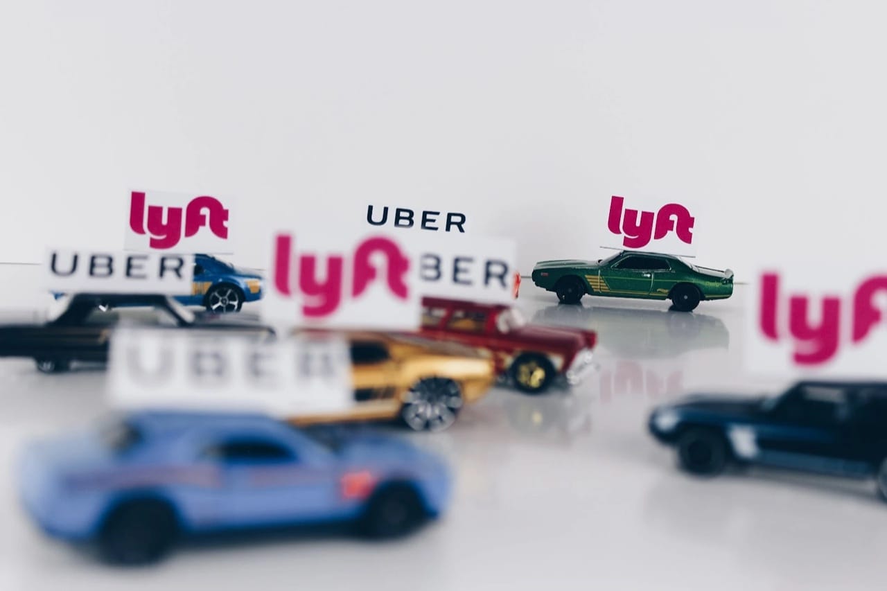A colorful model car with rideshare-app signage.